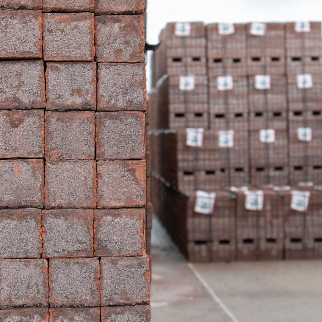 Photo of stacked brick cubes on a brick yard
